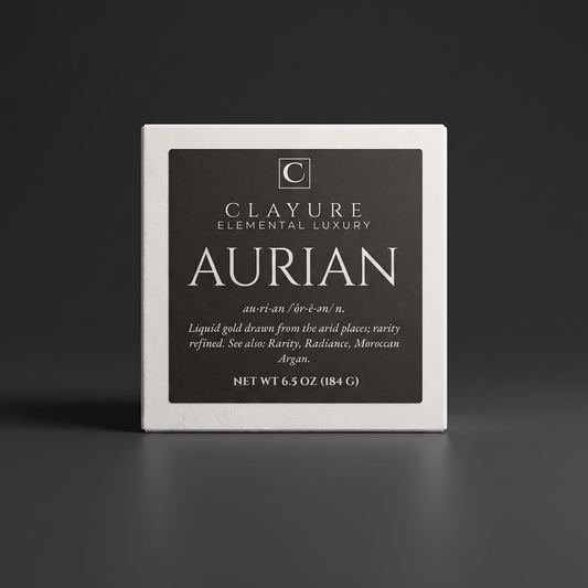 A square white bar of soap with a dark charcoal label reading 'Clayure Elemental Luxury Aurian' on a dark gray studio background.